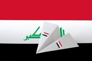Iraq flag depicted on paper origami airplane. Handmade arts concept photo