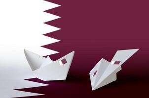 Qatar flag depicted on paper origami airplane and boat. Handmade arts concept photo