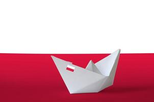 Poland flag depicted on paper origami ship closeup. Handmade arts concept photo