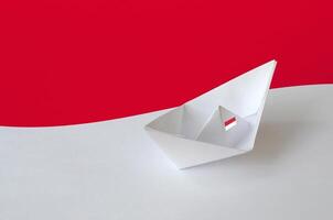 Monaco flag depicted on paper origami ship closeup. Handmade arts concept photo