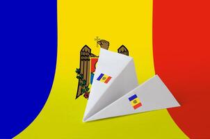 Moldova flag depicted on paper origami airplane. Handmade arts concept photo