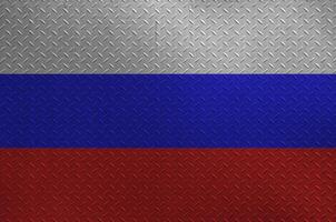 Russia flag depicted in paint colors on old brushed metal plate or wall closeup. Textured banner on rough background photo