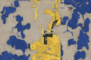 Barbados flag depicted in paint colors on old obsolete messy concrete wall closeup. Textured banner on rough background photo