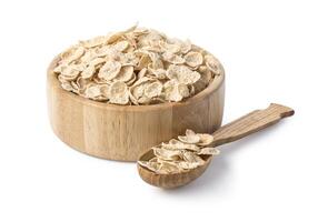 Oatmeal in wooden bowl and spoon photo