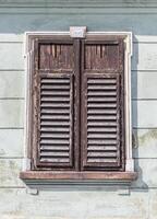window with closed shutters photo