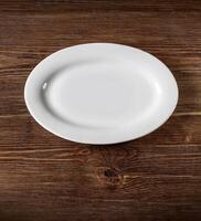 white plate on wooden table photo