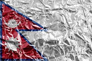 Nepal flag depicted in paint colors on shiny crumpled aluminium foil closeup. Textured banner on rough background photo