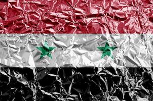 Syria flag depicted in paint colors on shiny crumpled aluminium foil closeup. Textured banner on rough background photo