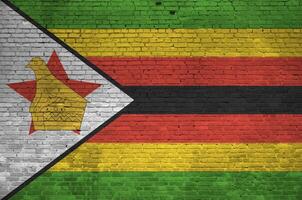 Zimbabwe flag depicted in paint colors on old brick wall. Textured banner on big brick wall masonry background photo