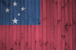 Samoa flag depicted in bright paint colors on old wooden wall. Textured banner on rough background photo