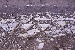 Background of shattered stony stones surface in mountain area. Texture with natural light photo