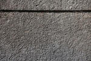 Plastered wall texture with rough relief mortar and light gray color photo