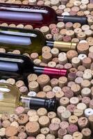 Glass bottle of wine with corks photo