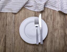 Empty plate on tablecloth photo