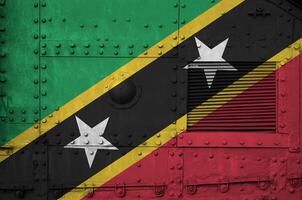 Saint Kitts and Nevis flag depicted on side part of military armored tank closeup. Army forces conceptual background photo