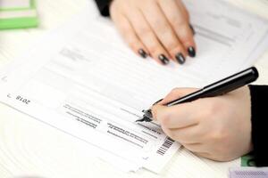 Accountant fill german tax form Einkommensteuererklarung in end of tax period. Taxation and paperwork routine photo