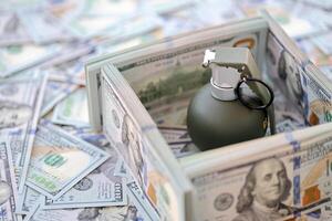 Grenade with a check against the background of huge amount of american dollar bills photo