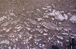 Background of shattered stony stones surface in mountain area. Texture with natural light photo