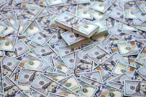 Very big amount of US hundred dollar bills. Huge quantity of united states currency notes on flat table photo