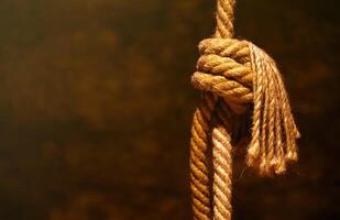 Noose in prison of old castle cellar and grunge stone wall photo