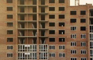 View of a large construction site with buildings under construction and multi-storey residential homes. Housing renovation photo