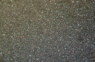 Surface grunge rough of asphalt. Tarmac dark grey grainy road. Texture Background Top view photo