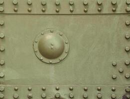 The texture of the wall of the tank, made of metal and reinforced with a multitude of bolts and rivets. Images of the covering of a combat vehicle from the Second World War photo