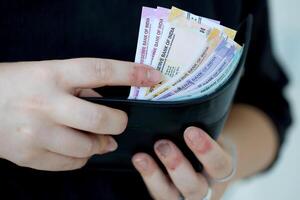 Woman hand with indian rupees bills. Concept of financial operations in cash in India photo