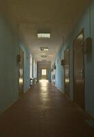 The gloomy corridor of a neglected public building. Public space in a poor residential high-rise building photo