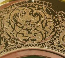 An old forged floral pattern is located above the front door to the Ukrainian building of the 19th century photo