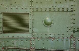 The texture of the wall of the tank, made of metal and reinforced with a multitude of bolts and rivets. Images of the covering of a combat vehicle from the Second World War photo