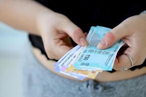 Woman hand with indian rupees bills. Concept of financial operations in cash in India photo