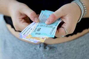 Woman hand with indian rupees bills. Concept of financial operations in cash in India photo