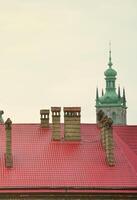 Fragment of a metal roof of the restored old multi-storey building in Lviv, Ukraine photo