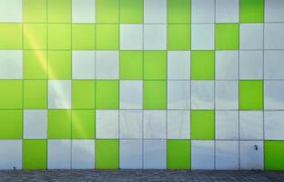 The texture of the metal wall, framed in the form of colored squares of two colors. Modern wall design for the exterior of residential and office buildings photo