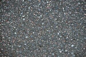 Surface grunge rough of asphalt. Tarmac dark grey grainy road. Texture Background Top view photo