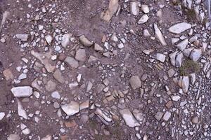 Background of shattered stony stones surface in mountain area. Texture with natural light photo