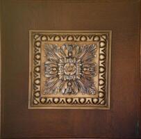 Elegant dark brown ceiling with stone patterns and a rosette texture photo