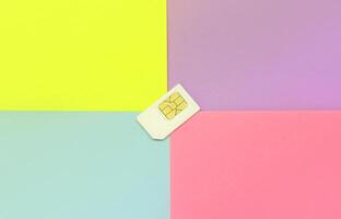 Subscriber identity module. White SIM card on pastel background photo