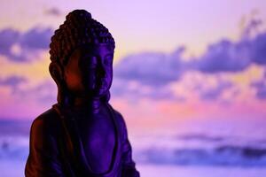 Buda purnima y vesak día concepto, Buda estatua con bajo llave ligero en contra hermosa y vistoso antecedentes. meditación foto