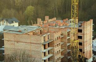 View of a large construction site with buildings under construction and multi-storey residential homes. Housing renovation photo