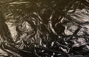 Texture of black plastic garbage disposable bag photo