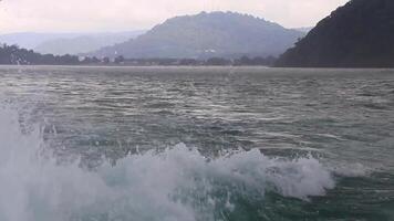 Travel Thailand by ferry boat yacht waves through tropical landscape. video