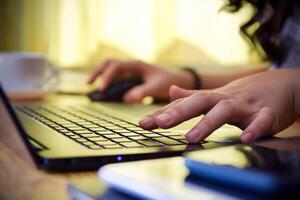 Women using laptop working and drink coffee cup hot at home photo