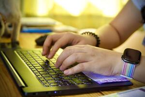 Women using laptop working and drink coffee cup hot at home photo