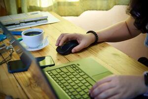 Women using laptop working and drink coffee cup hot at home photo