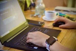 Women using laptop working and drink coffee cup hot at home photo