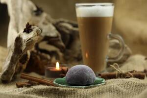 Glass coffee with mochi and spices. Cloth background with copy space photo