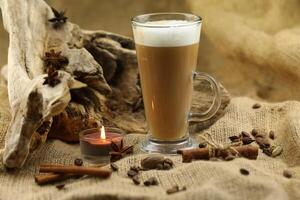 Glass coffee with spices. Cloth background with copy space photo