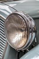 Headlight of old vintage car photo